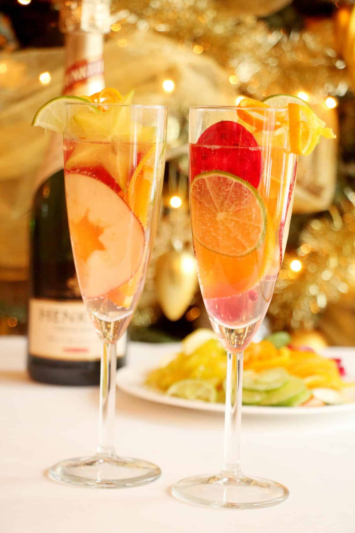 two champagne flutes filled with sangria and fruit