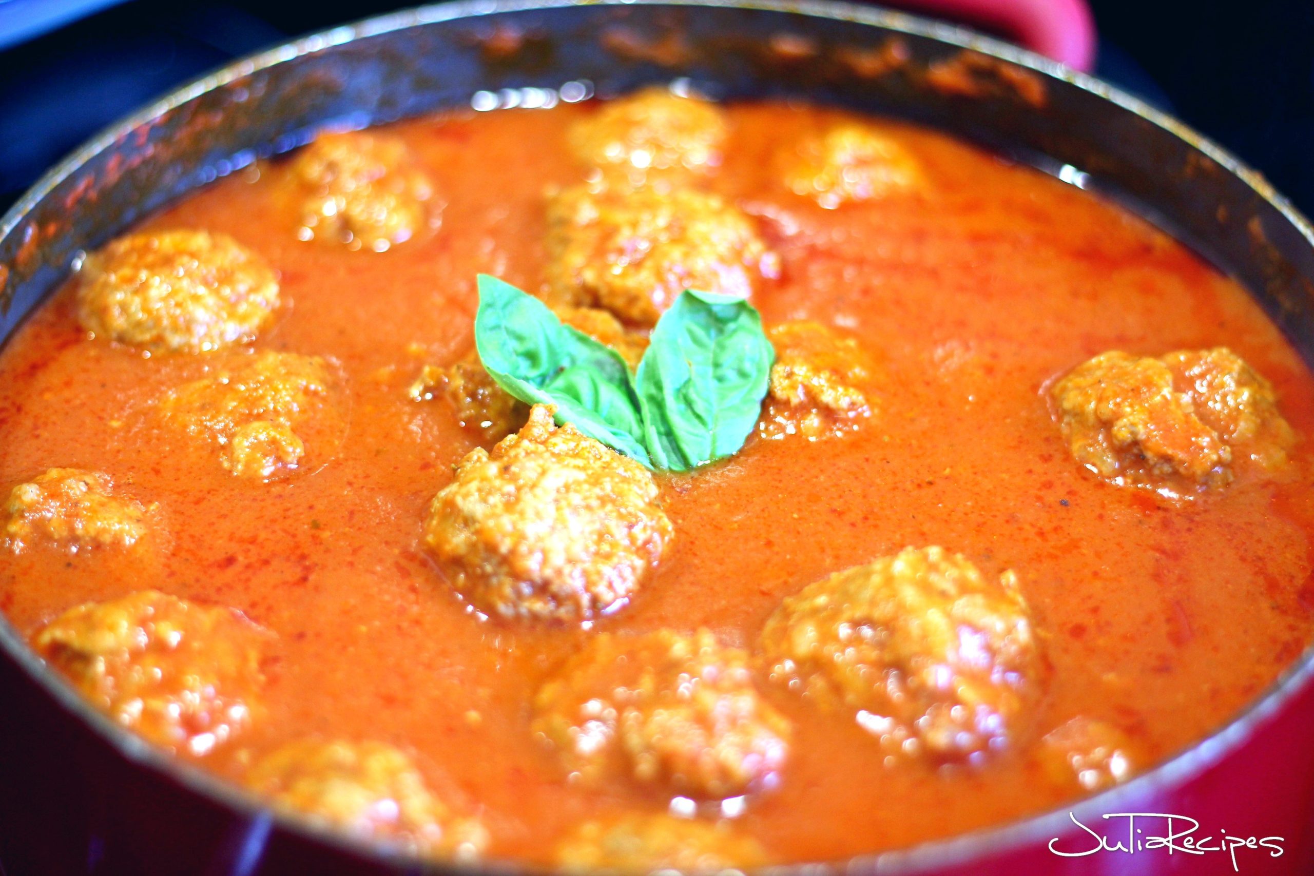 large sauce pot with meatballs in tomato sauce