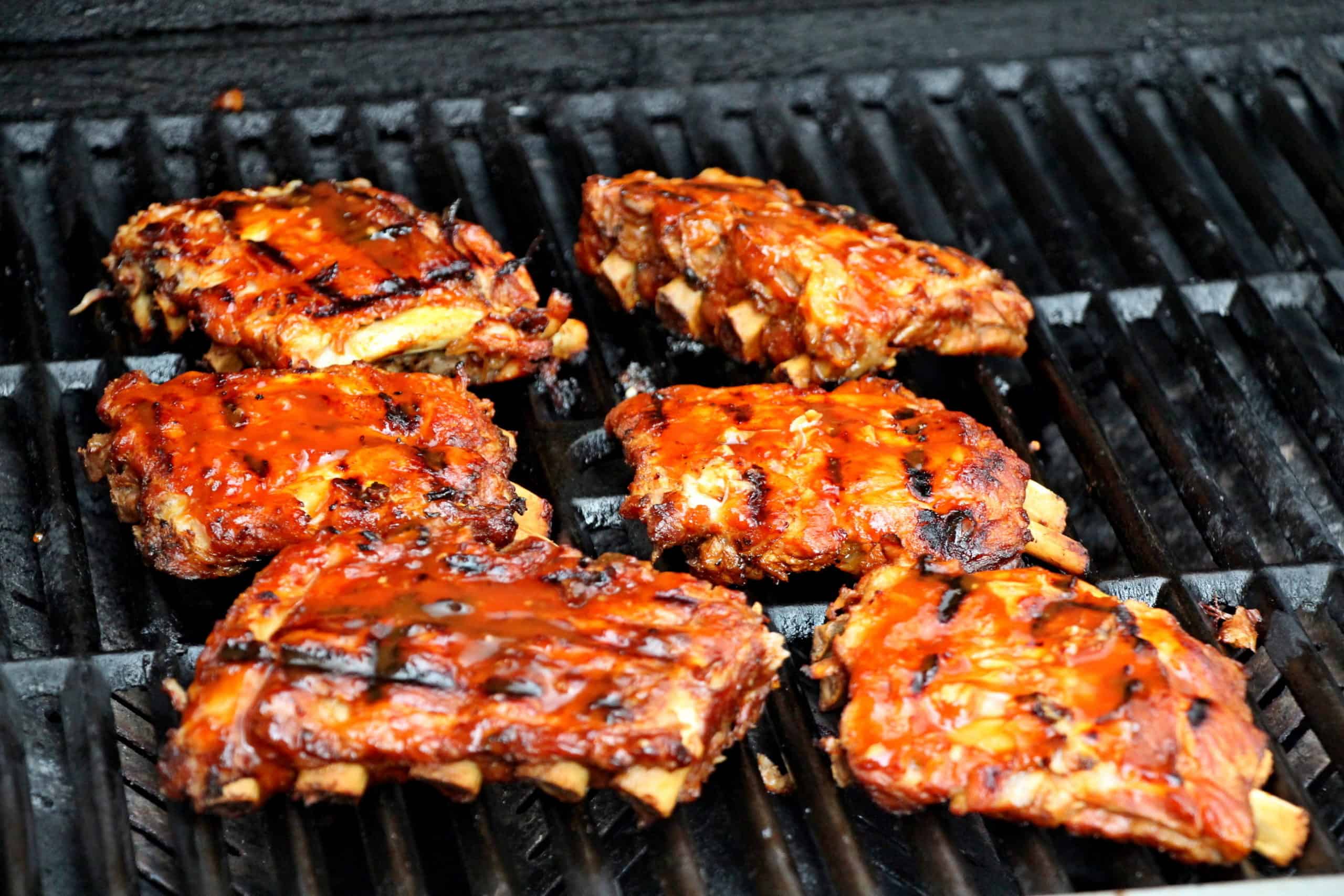 ribs on the grill with bbq sauce