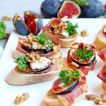 crostini with figs and prosciutto topped with goat cheese