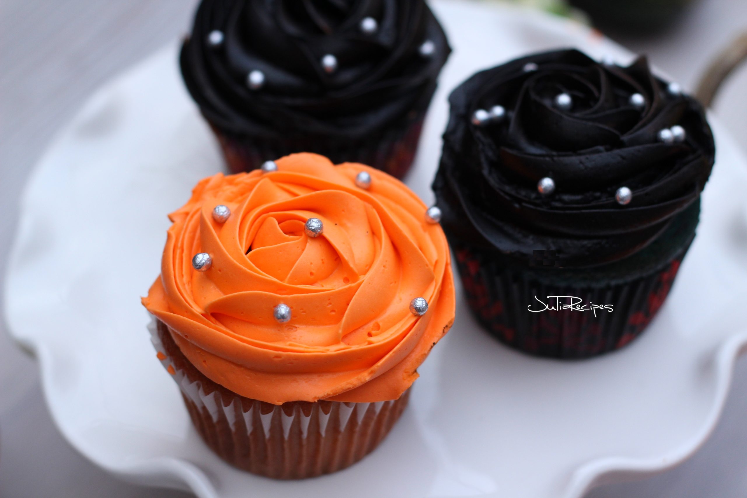 vanilla cupcakes with orange and black icing