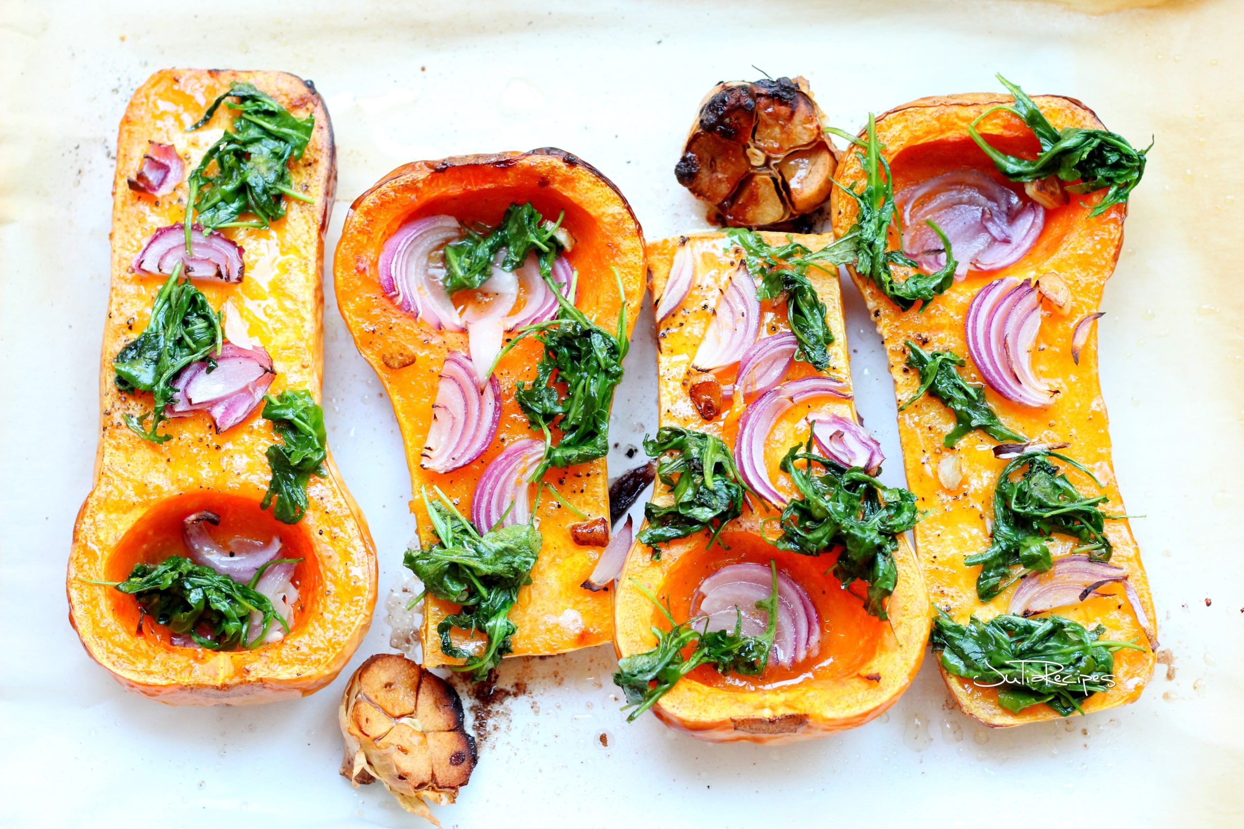 butternut squash dressed with arugula and red onion, with garlic