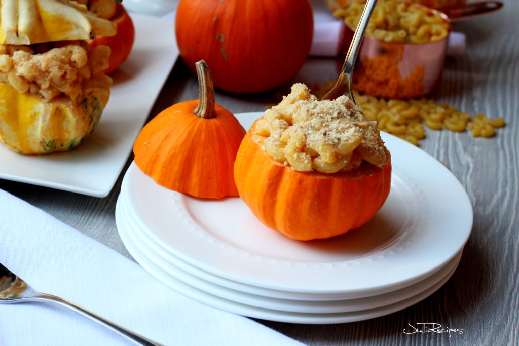Pumpkin filled with macaroni and cheese on white plate