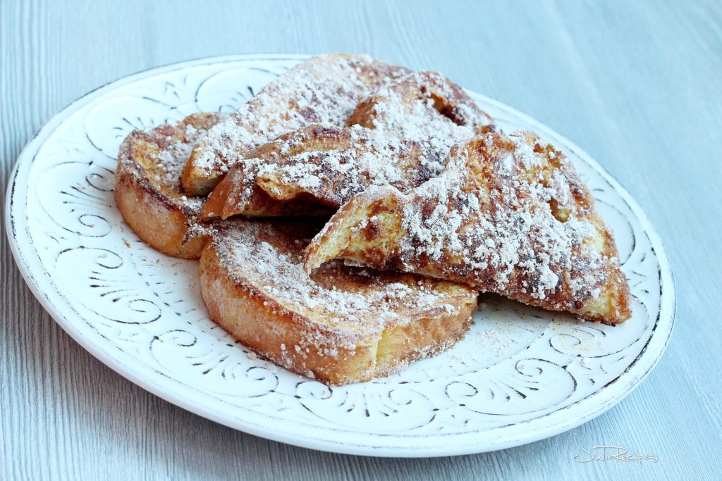 french toast covered with powdered sugar and cinnamon