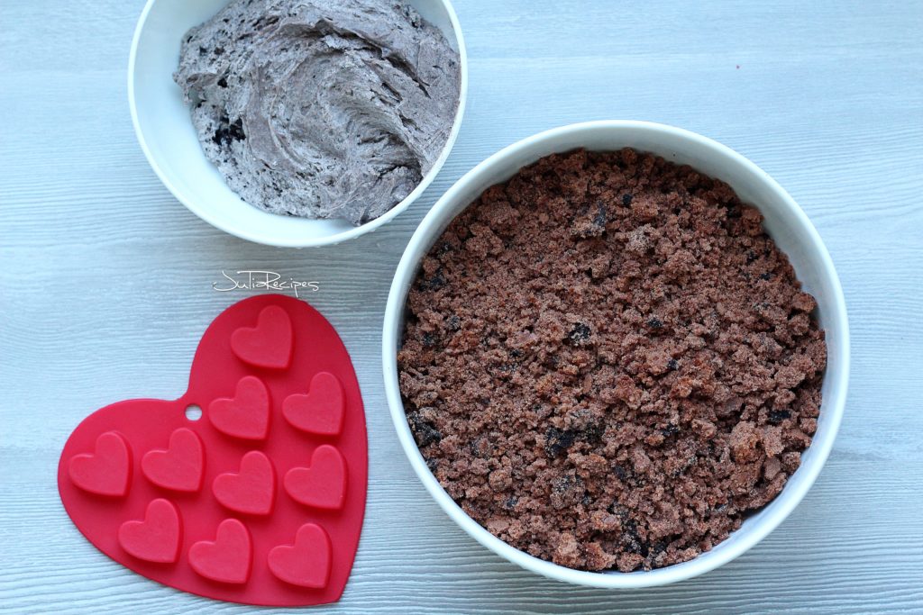 chocolate cake mix in one bowl and oreo buttercream in another bowl with heart mold