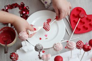 red heart cake pop being decorated