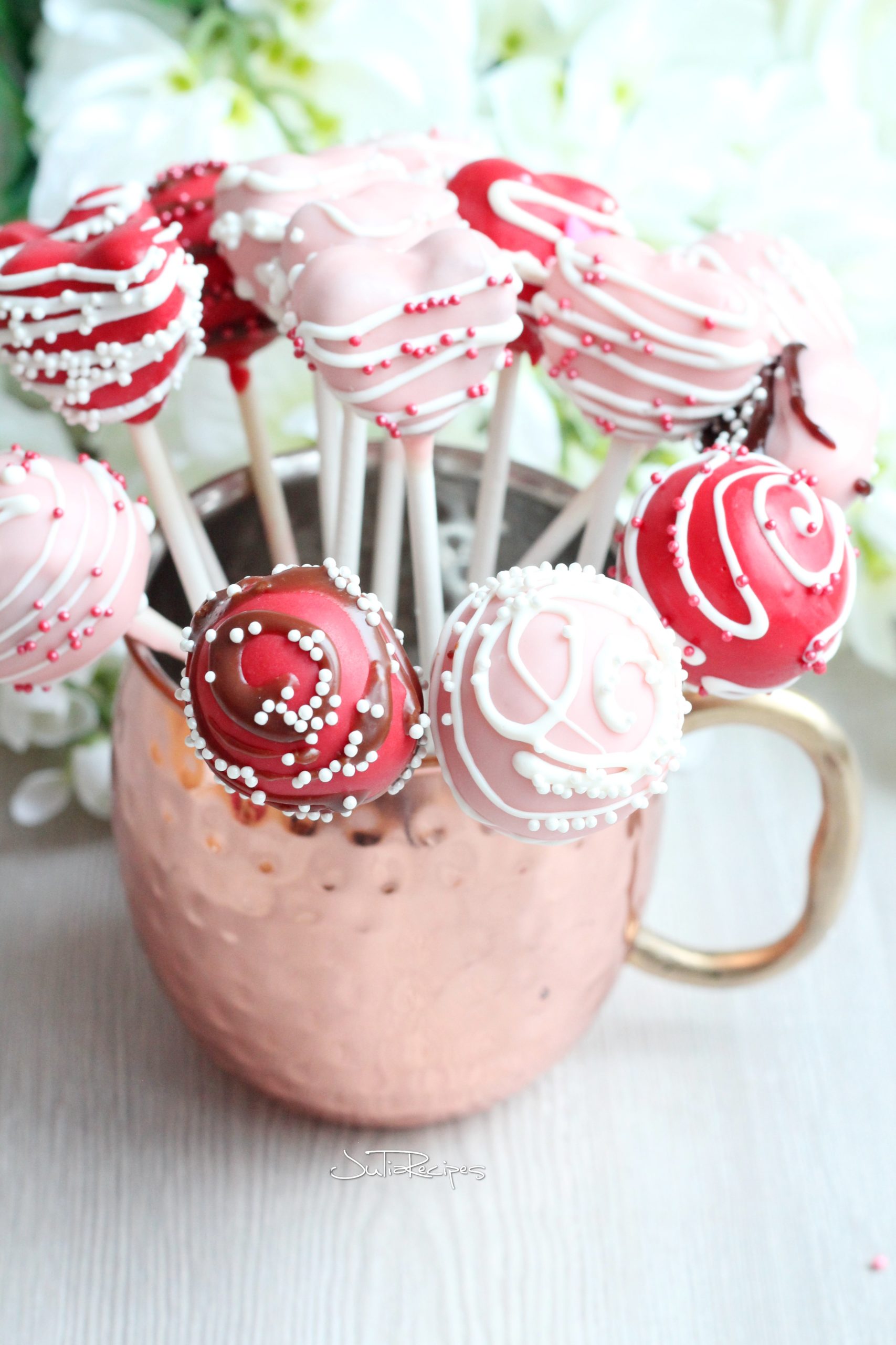 pink and red cake pops in mug