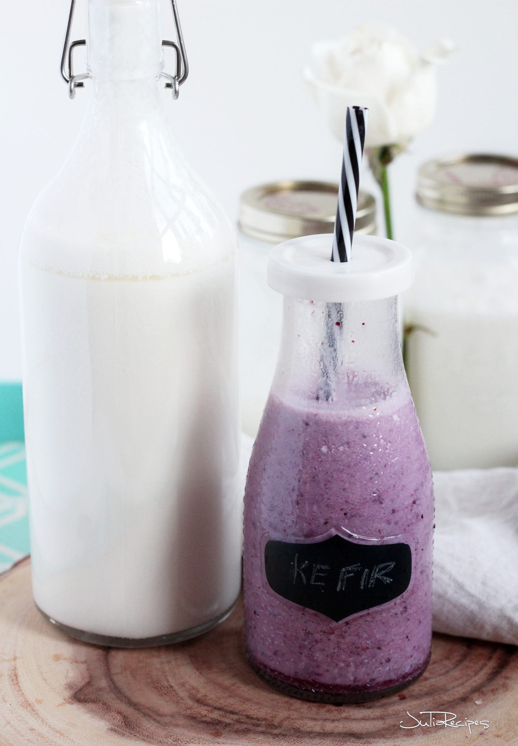 Blueberry kefir in drinking jar with plain kefir in milk jar