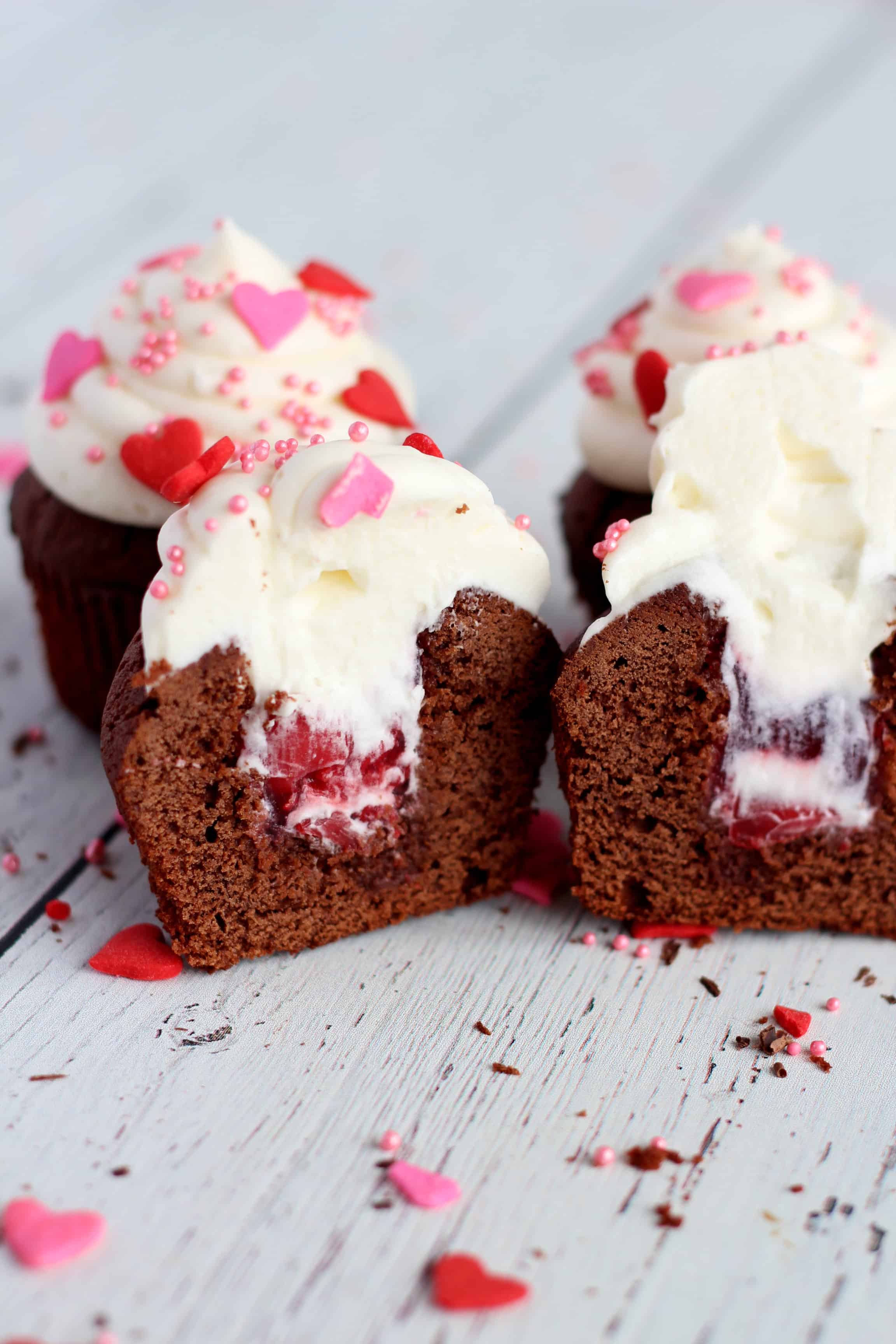 cupcakes with cherry filling and whipped cream
