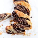 chocolate and poppy seed cut on pieces babka on parchment paper