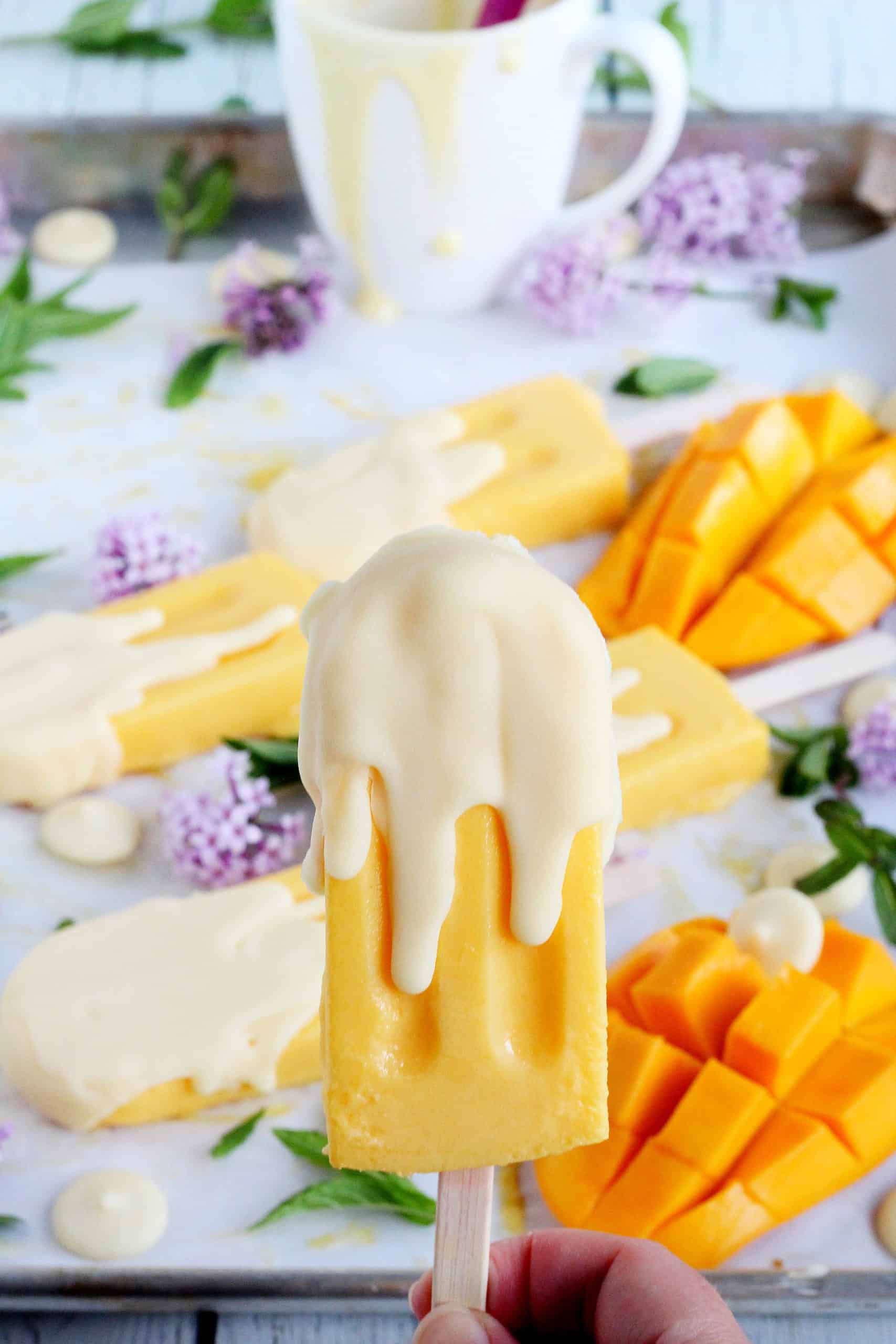 close up of mango ice cream on stick