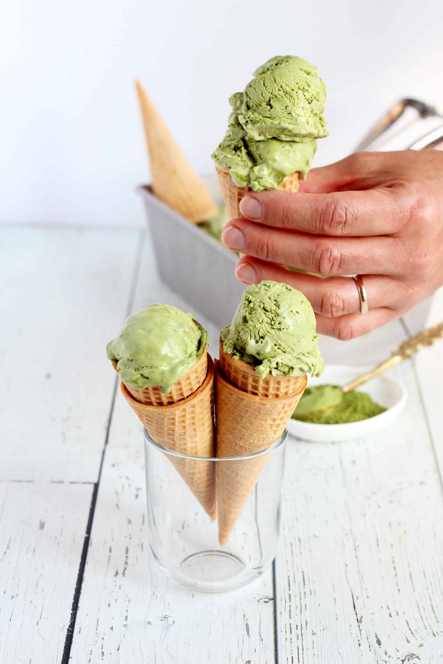 matcha green tea no churn ice cream hand holding the cone ice cream