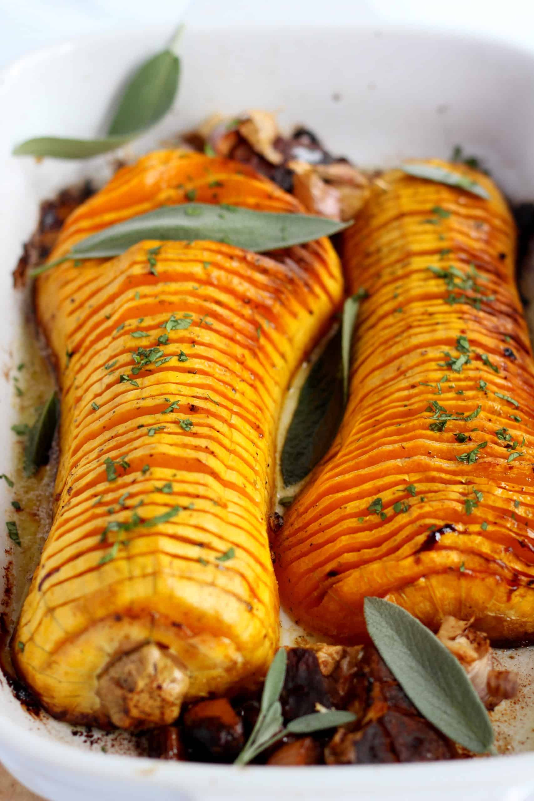 baked hasselback butternut squash with sarfan leaves and galic bulbes