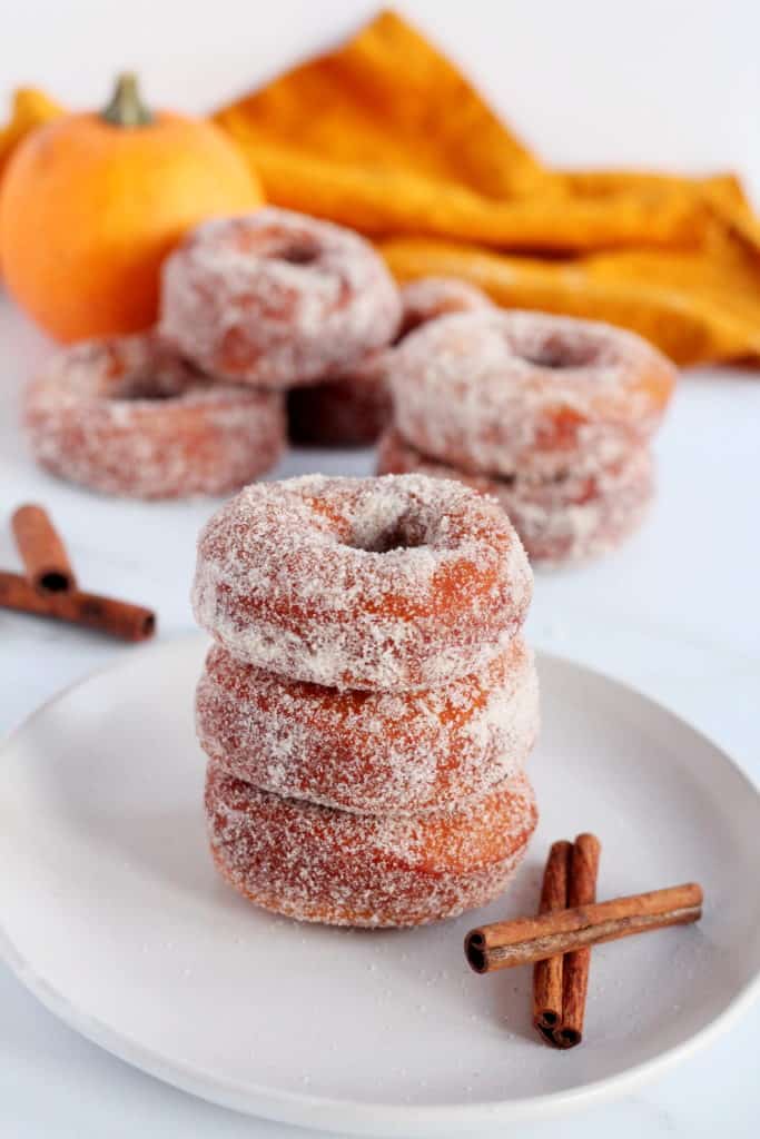 three pumpkin donuts stacked on each other