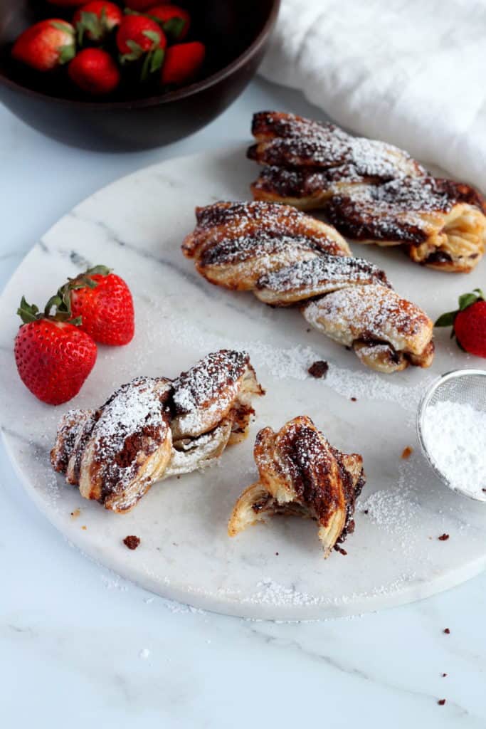 Baked Nutella Puff Pastry Twists and dust with sugar