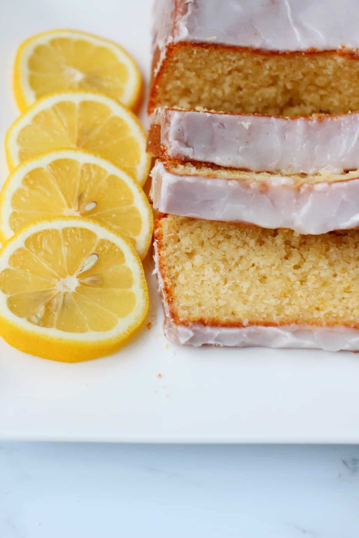 Lemon pound cake cut in slices with slices  of lemons for decoration
