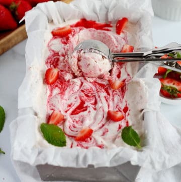 strawberry ice cream in loaf pan with scoop spoon