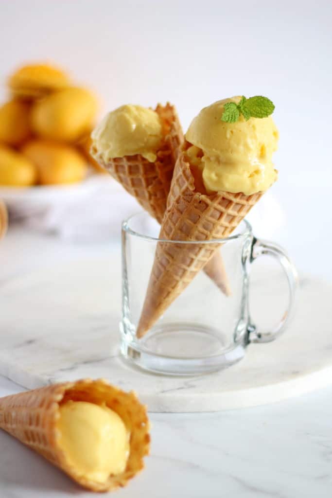 mango sherbet in waffle cones topped with mint leaves