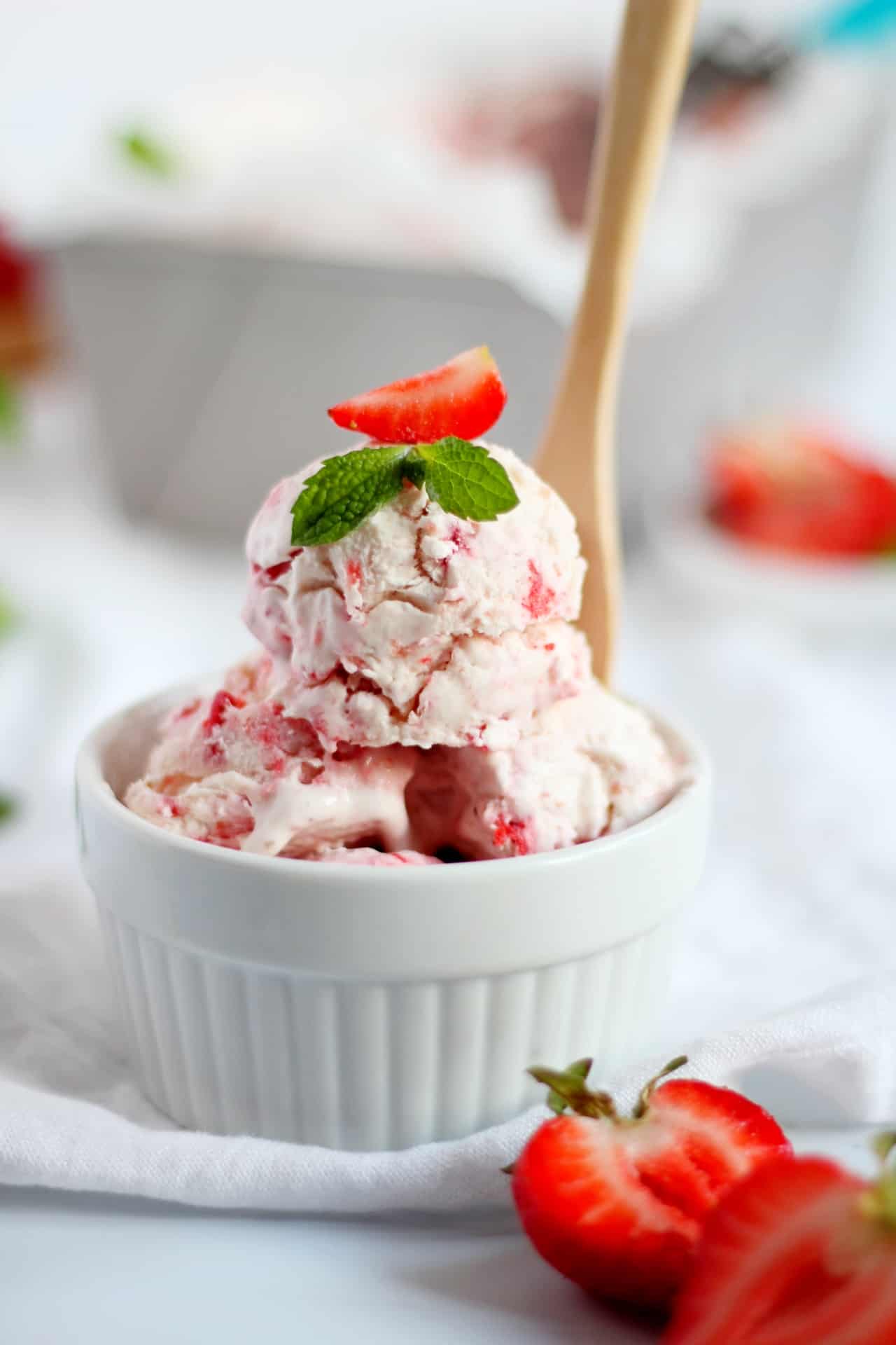 close up of strawberry ice cream in white bowl