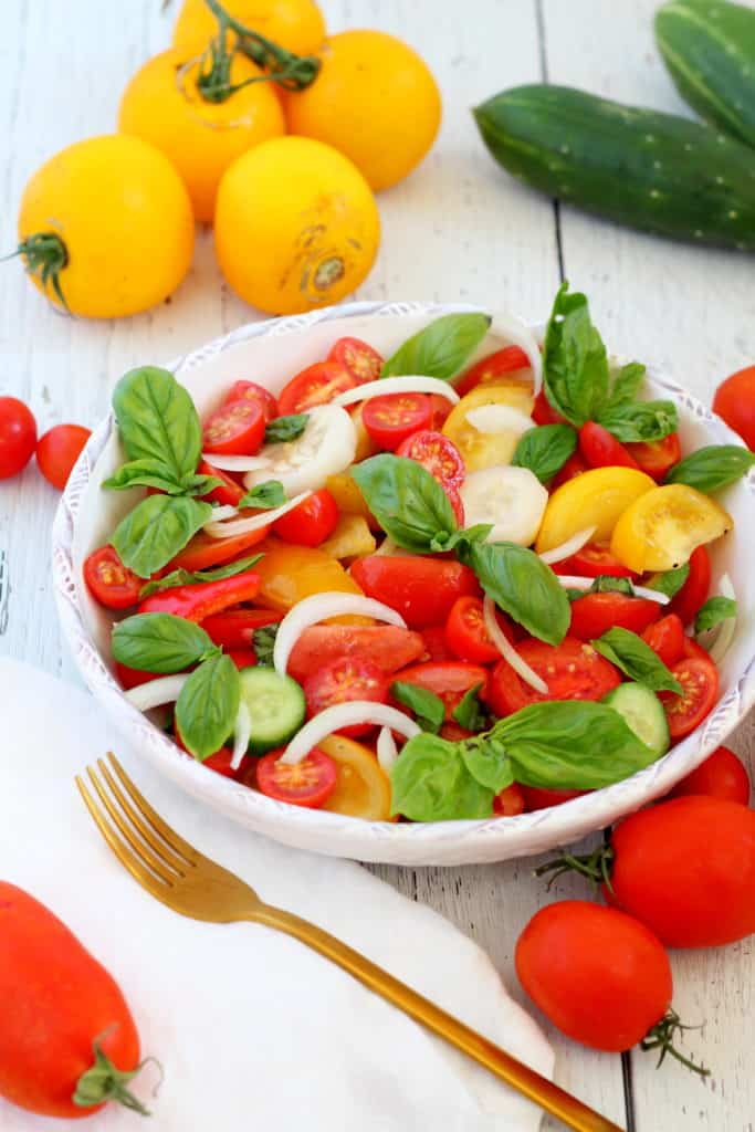 tomato and cucumber salad in white bowl