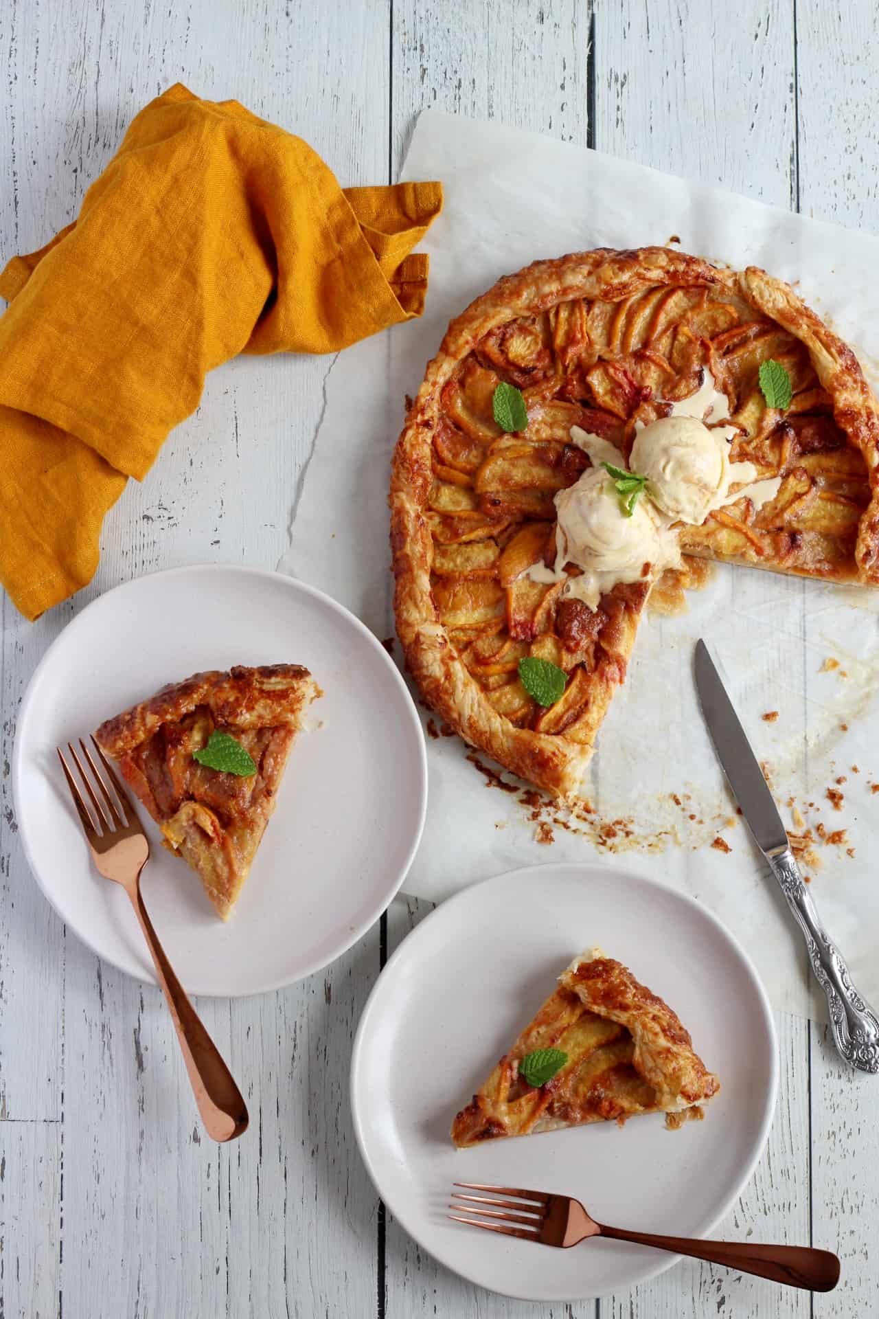galette filled with peaches with two pieces cut out from the galette
