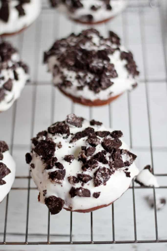 oreo donuts covered with cream cheese icing and pieces of oreo