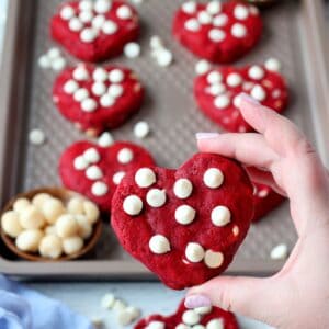 heart shaped red velvet cookie in hand