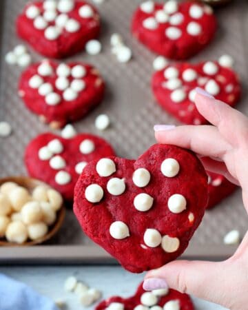 heart shaped red velvet cookie in hand