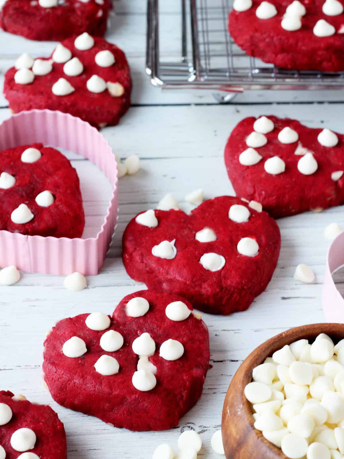 Red velver heart shaped cookies on white board