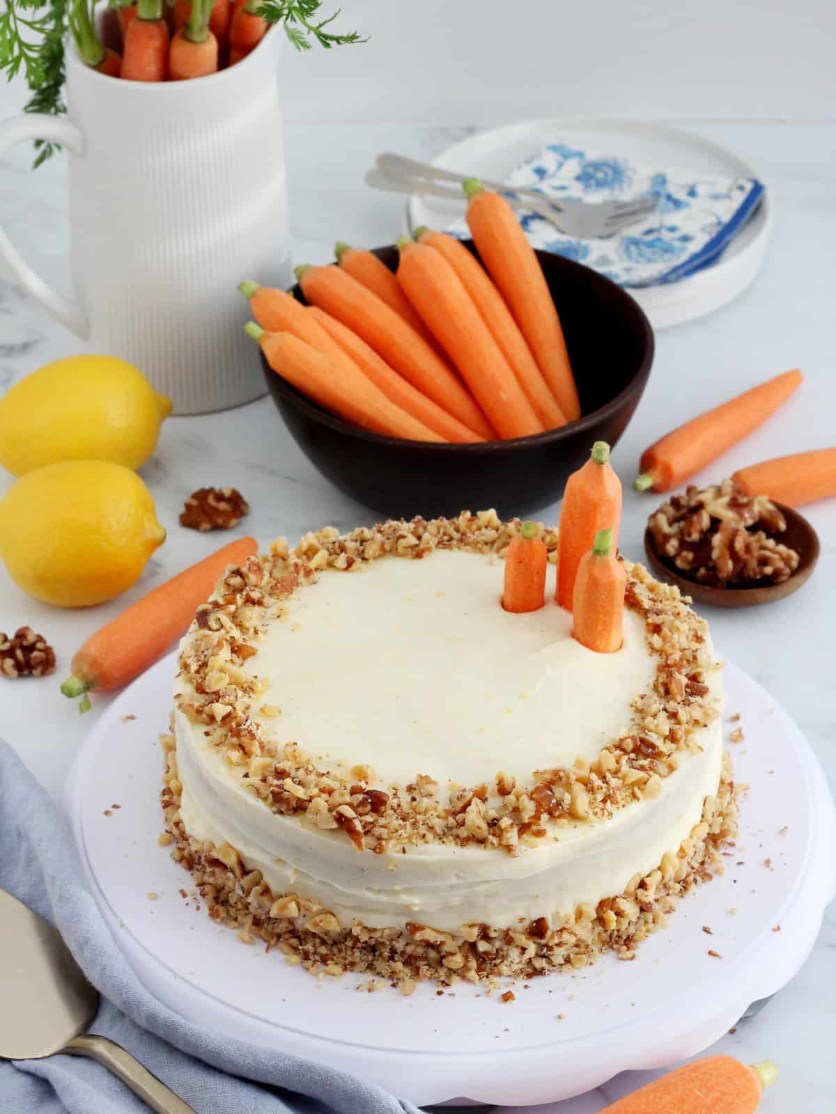 Carrot cake decorated with walnuts and whole carrots