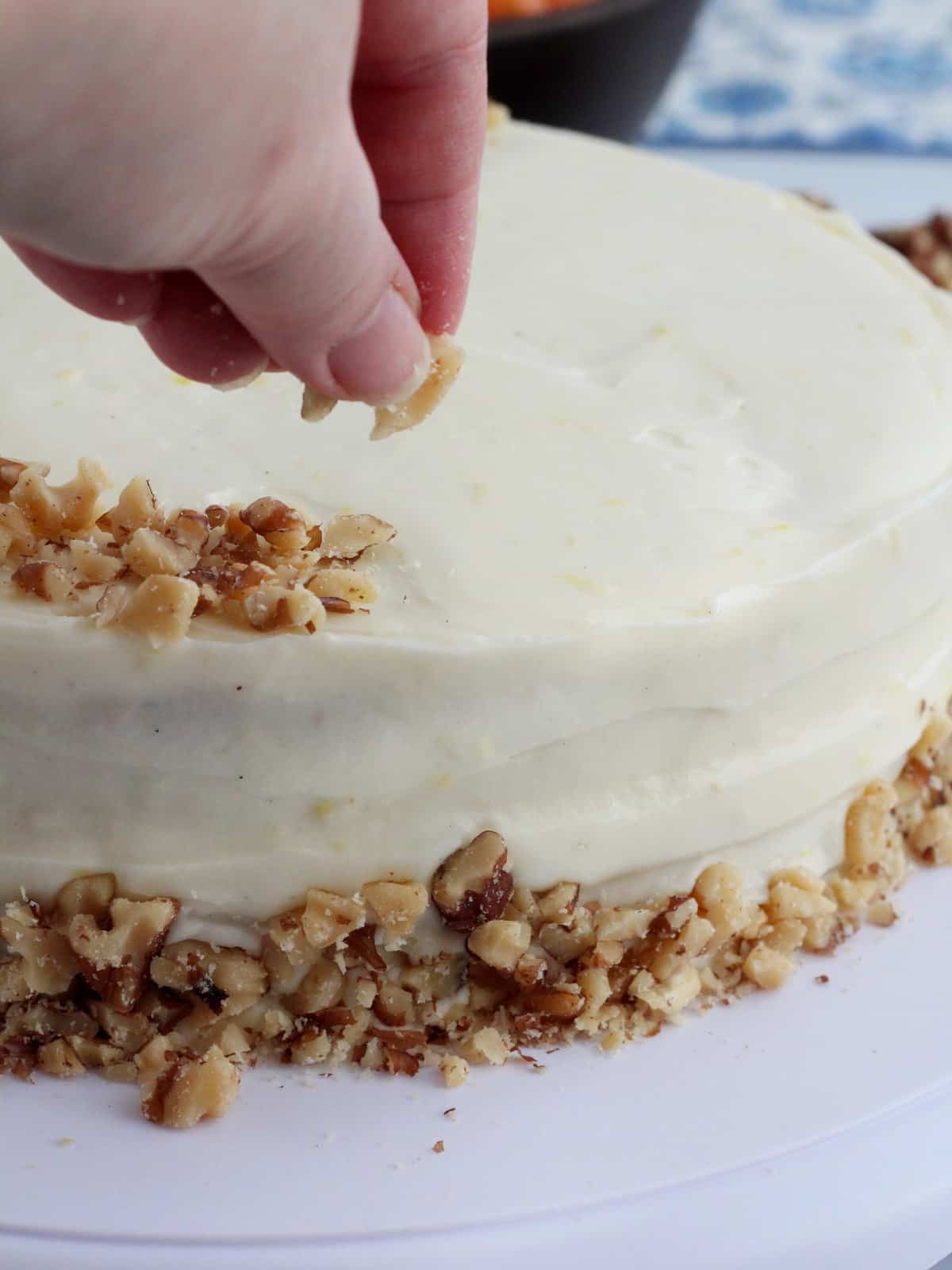 decorate carrot cake with chopped walnuts