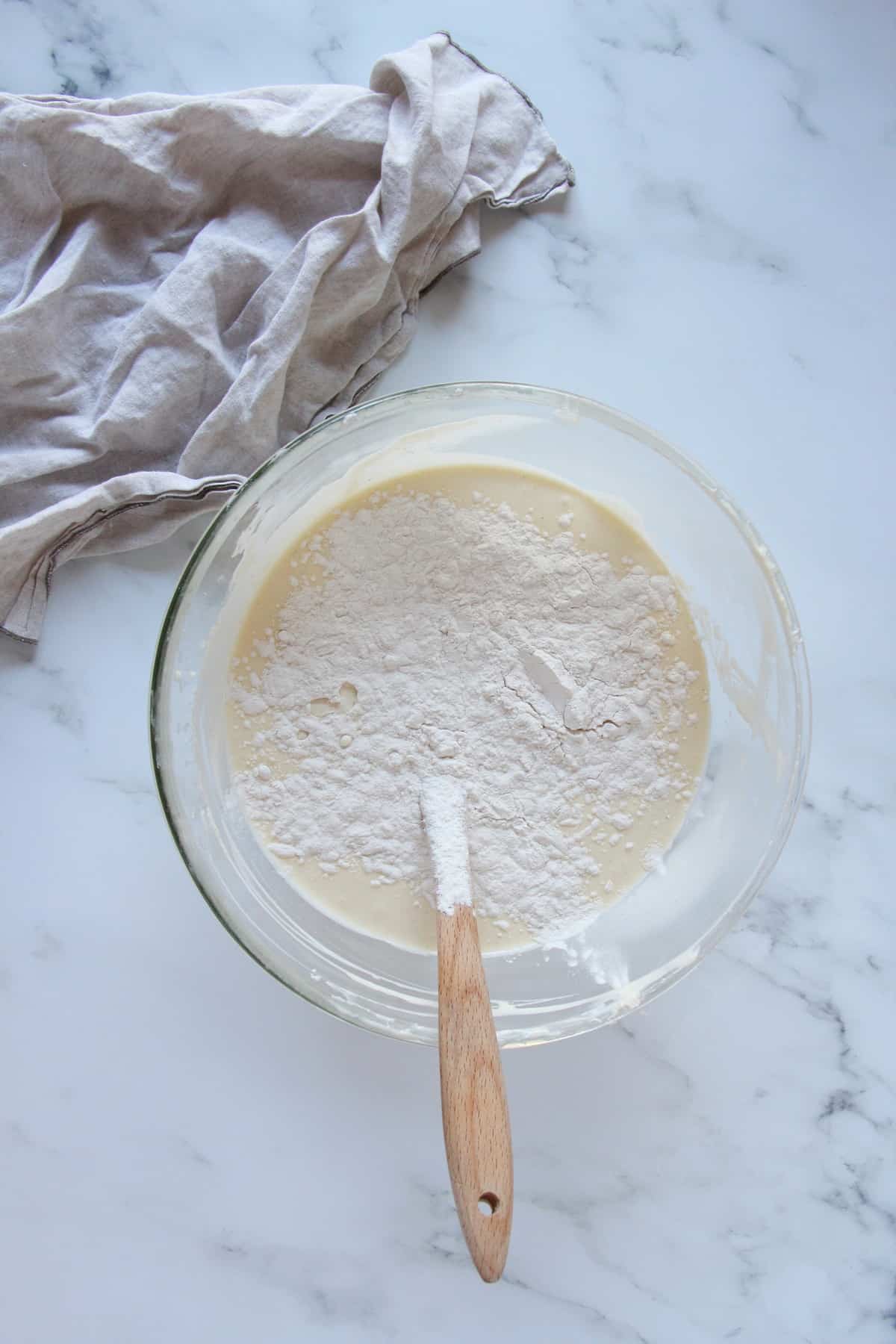 sifting flour into cheesecake