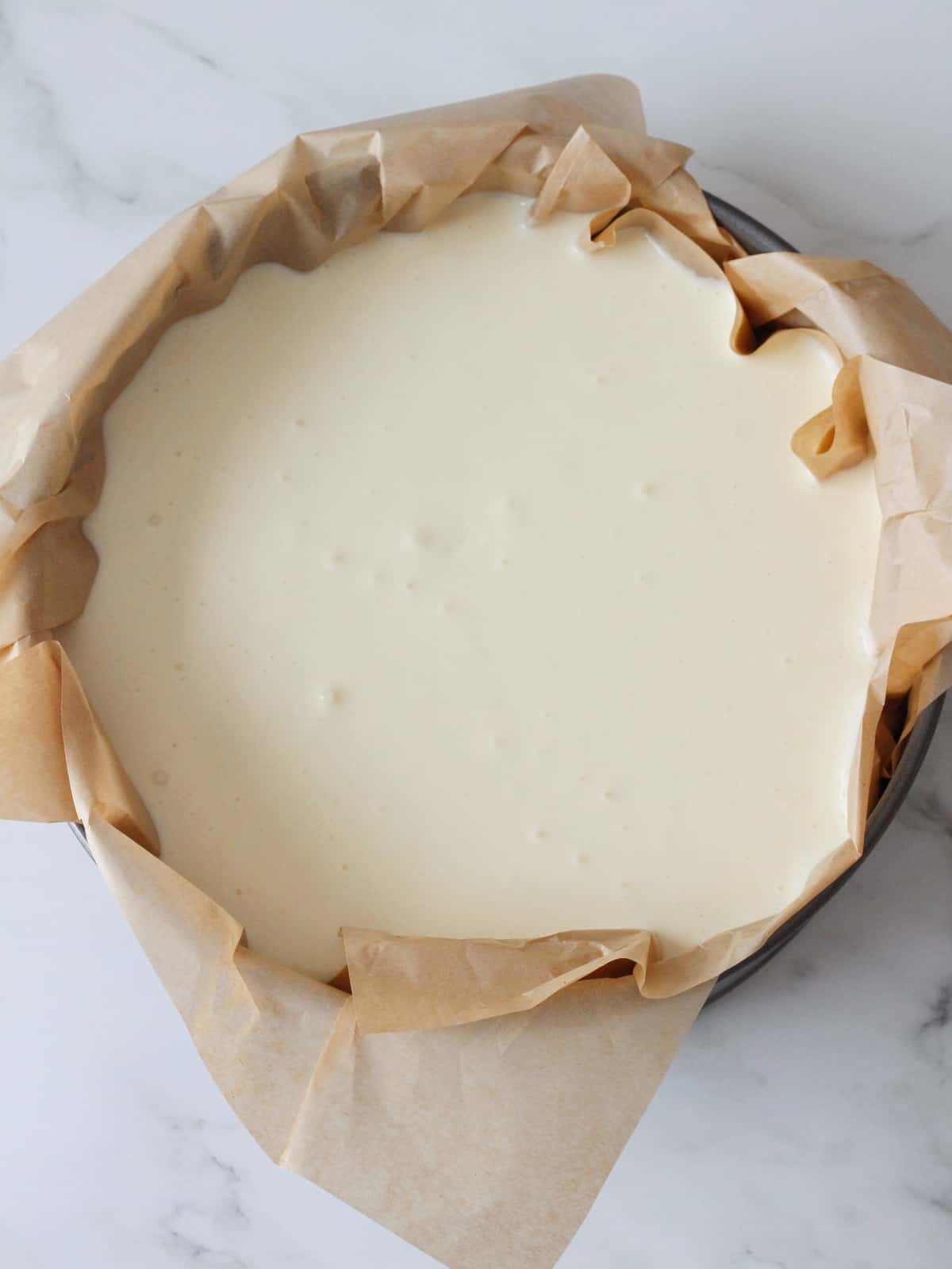 batter of basque cheesecake in springform pan