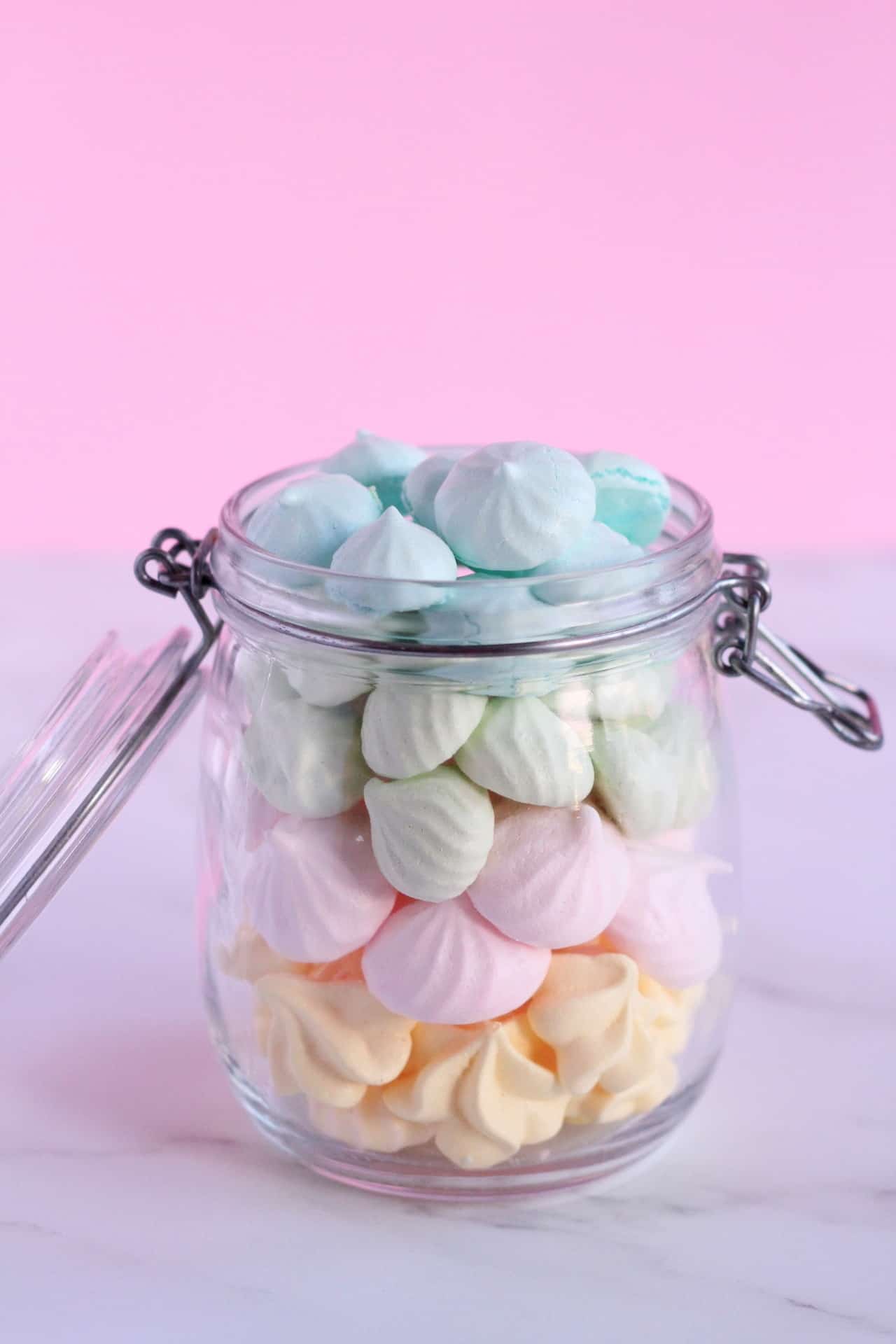 mini meringues in blue, gree, pink and yellow partel colors in jar