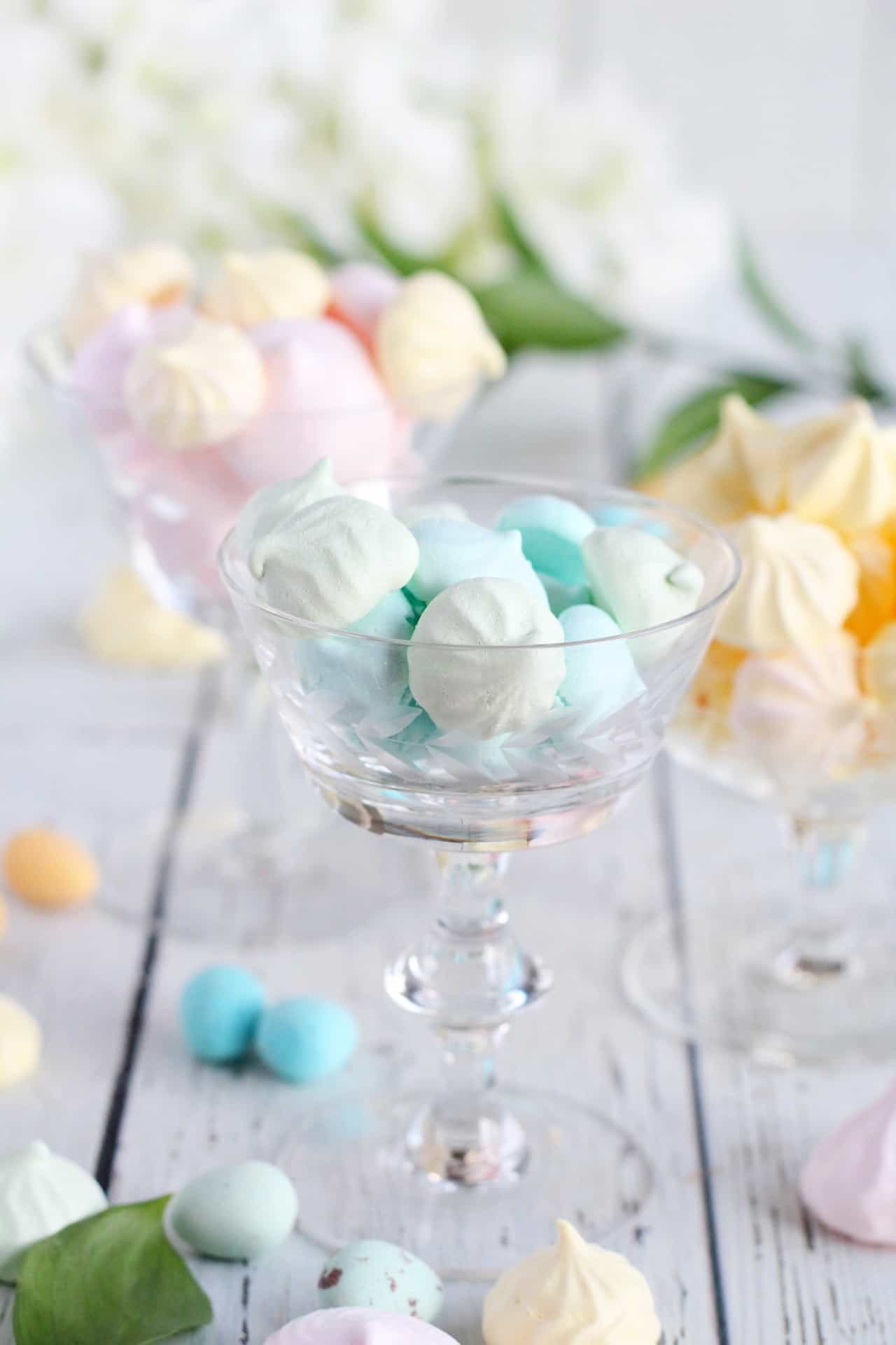 blue meringues in  vintage champagnglass with other small meringues of pastel colors behind