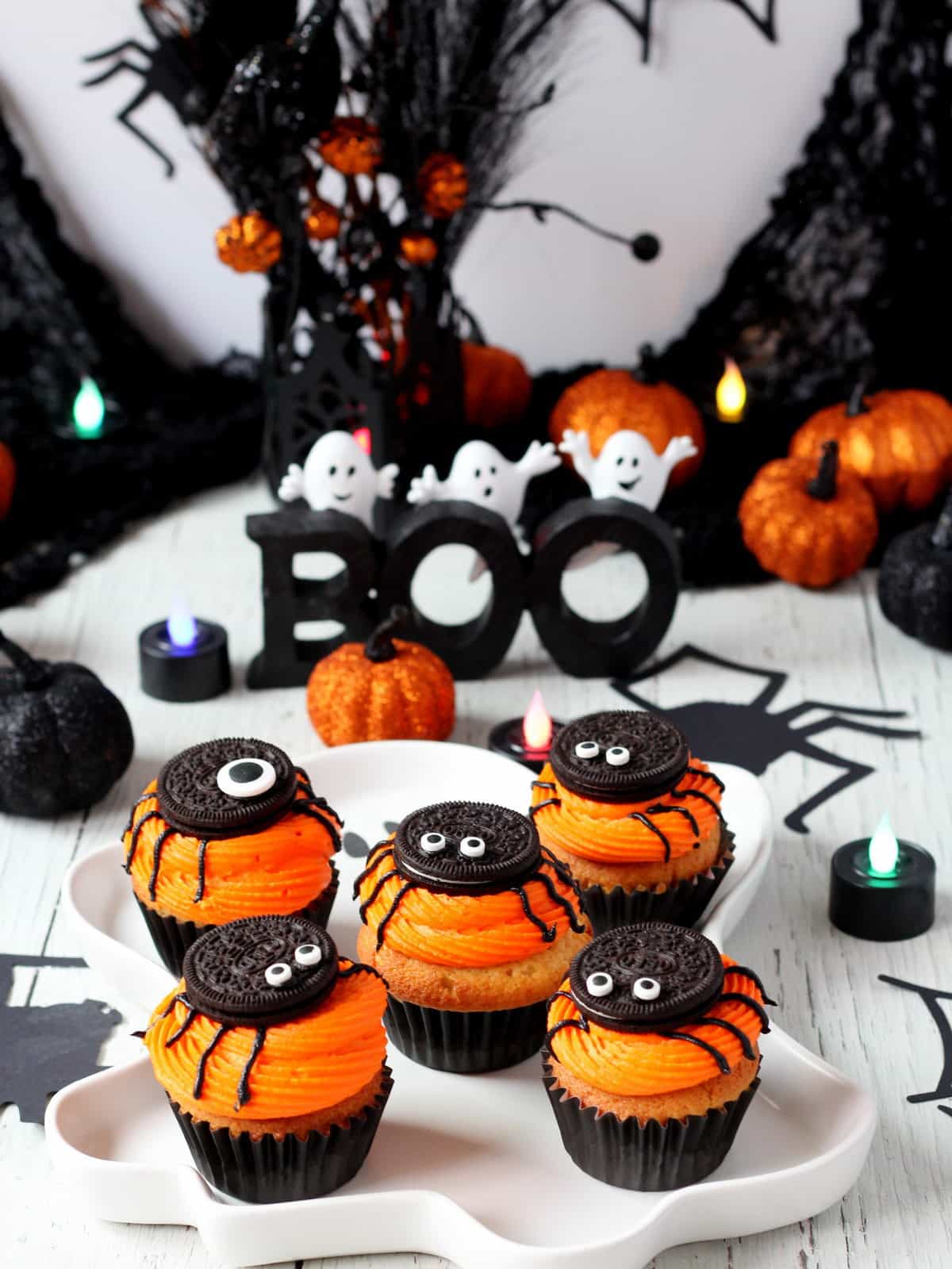 white ghost tray filled with spider cupcakes made from oreo cookies