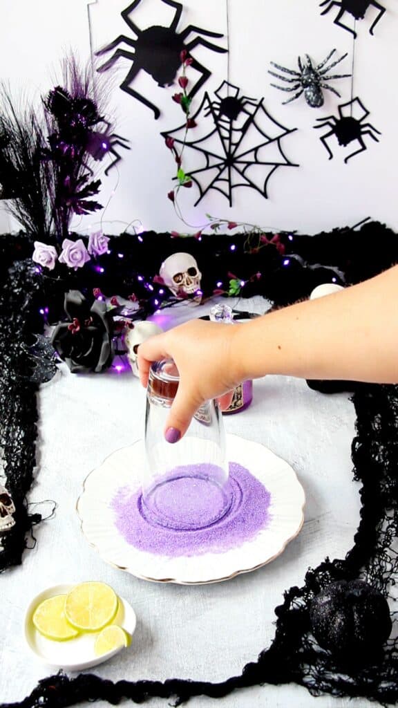 dipping glass in purple sugar
