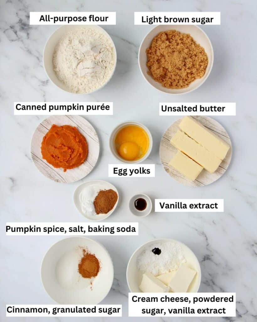 Ingredients for pumpkin cheesecake cookies placed in bowls with white background