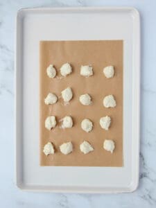 cheesecake filling dolloped onto brown parchment paper