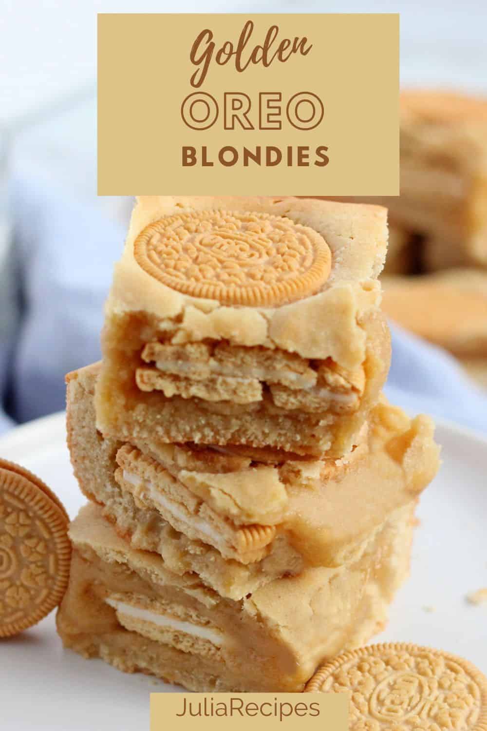 golden oreo blondies stacked on white plate with oreo cookies around