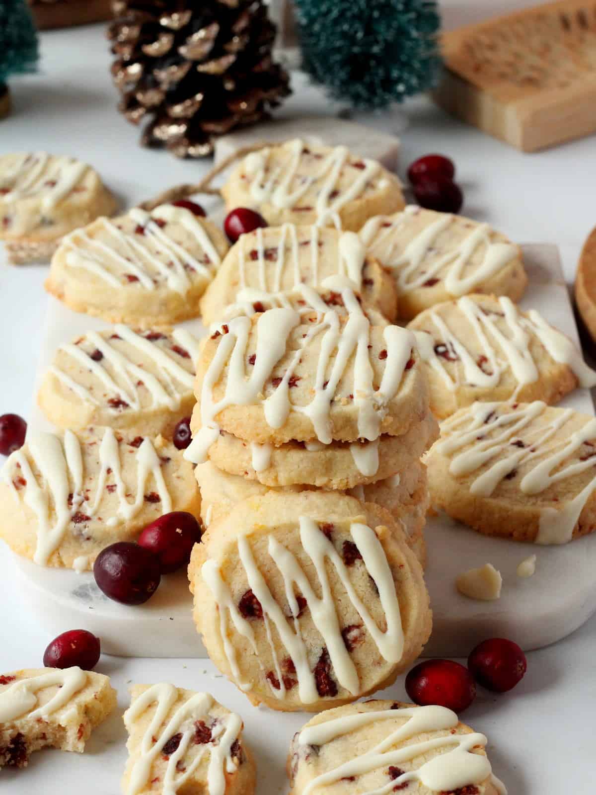 orange zest and cranberry cookies on white marble board, decorated with fresh cranberries on white marble board