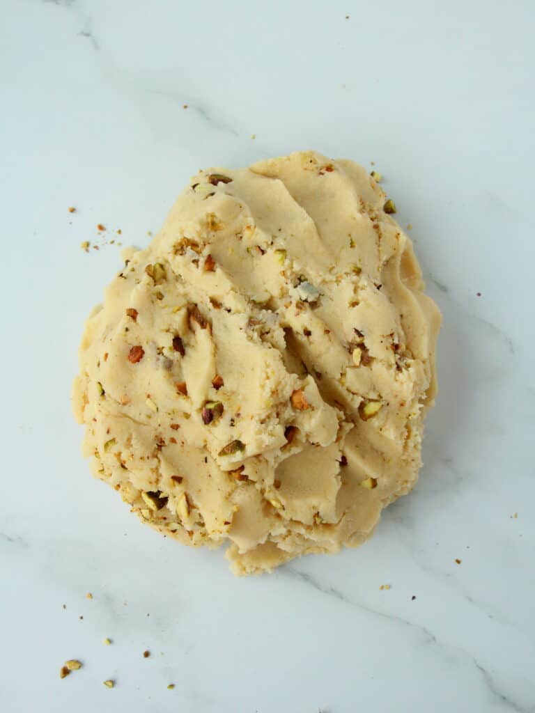 shortbread pistachio cookie dough with on white surgace