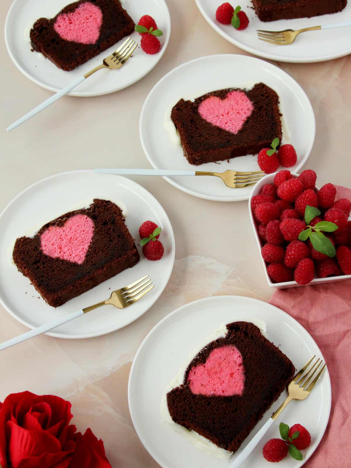 plates with slices of chocolate loaf cake with hidden pink heart