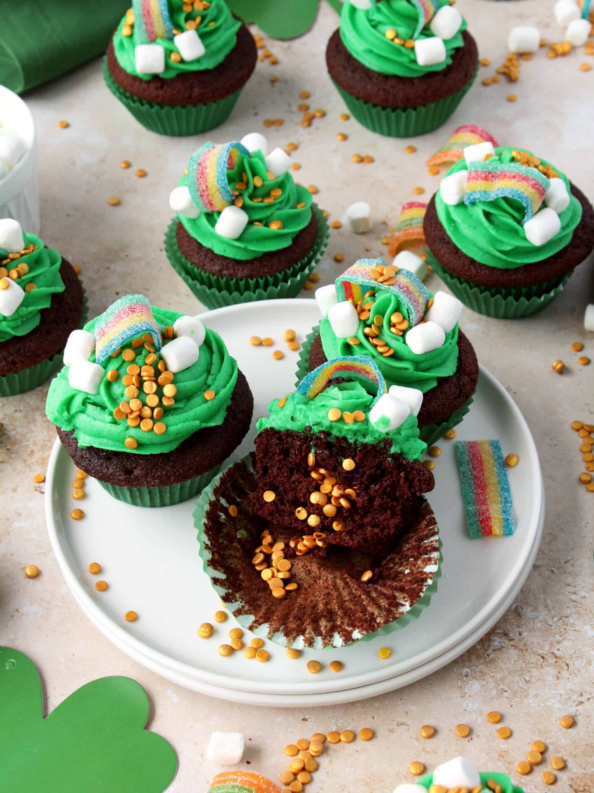 st patrick's day cupcakes decorated with green buttercream on white plate.