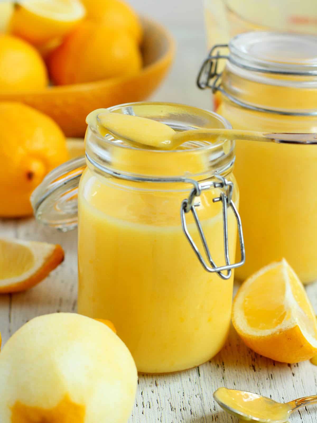 Homemade lemon butter in mason jars, with lemons around